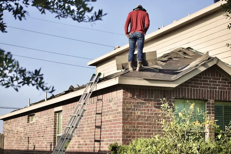 Professional roofer working on a residential roof in Eugene